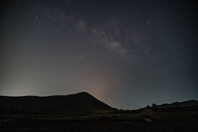 Scenic view of landscape against sky at night