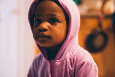Portrait of cute girl looking away at home