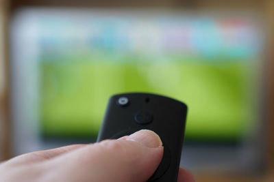 Close-up of hand holding smart phone outdoors