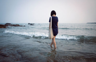 Full length of woman walking on beach 