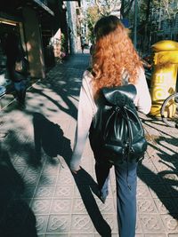 Woman standing on sidewalk