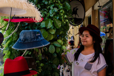 Girl wearing hat standing at market