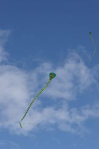 Low angle view of kite flying against blue sky