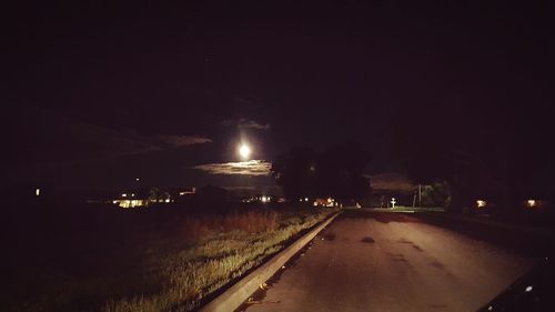 Illuminated lights against sky at night