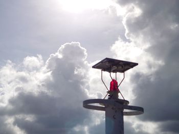 Low angle view of cross against sky on sunny day