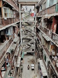 High angle view of woman standing amidst old building