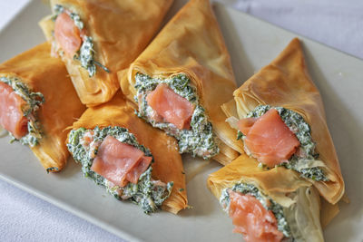 Filo dough cones stuffed with ricotta cheese, spinach and smoked salmon.