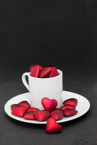 Close-up of coffee cup on table against black background