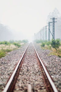 Surface level of railroad tracks against sky