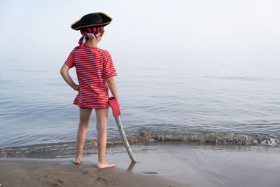 Full length of woman standing in sea