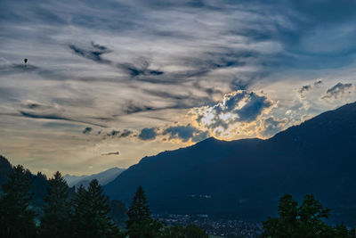 Low angle view of silhouette mountains against sky at sunset