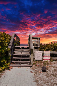 Empty staircase against sky during sunset