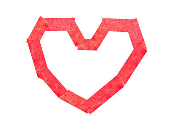 Close-up of red heart shape on white background