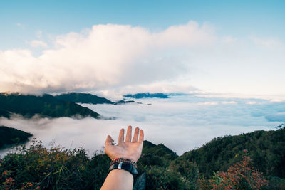 Person on mountain against sky