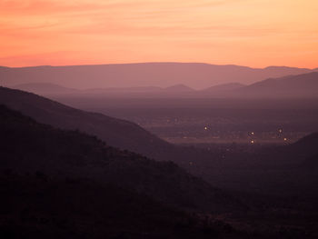 Scenic view of silhouette mountains against sky at sunset