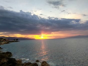 Scenic view of sea against cloudy sky