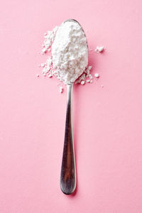 Close-up of ice cream cone against pink background