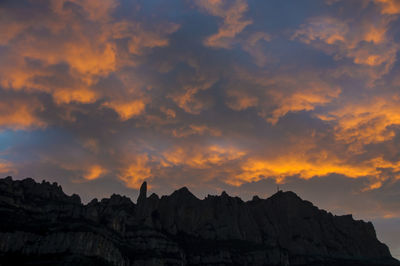 Low angle view of rock formation against sky during sunset