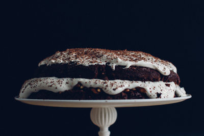 Close-up of cake against black background