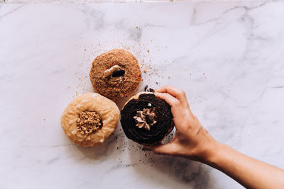 Cropped hand of person holding food on table