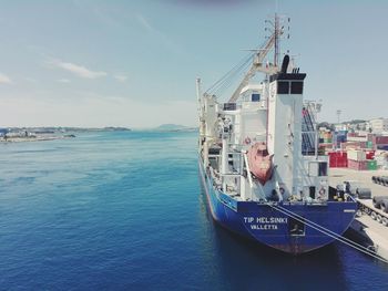 Ship moored at sea against sky