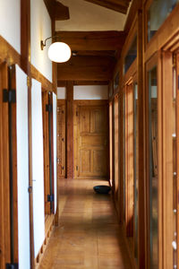 Empty corridor of illuminated building