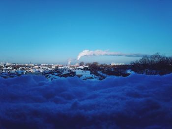 Panoramic view of snowcapped mountains against blue sky