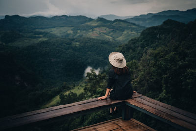 Man looking at mountain range against sky