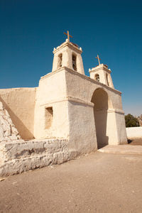 Low angle view of historic building against clear blue sky