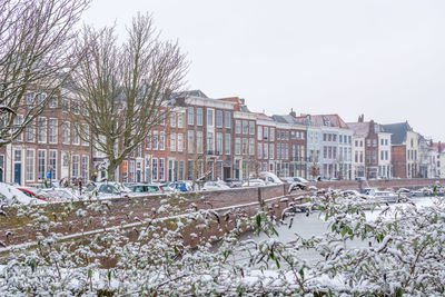 Buildings in city against clear sky during winter