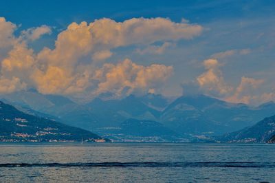 Scenic view of sea and mountains against sky