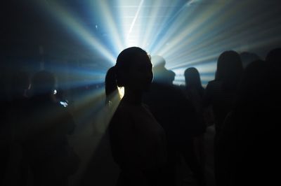 Silhouette people in illuminated nightclub