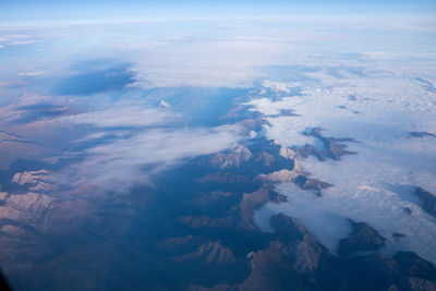 Aerial view of snowcapped mountains against sky