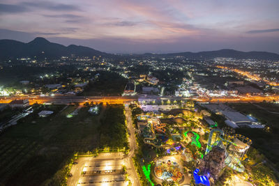 High angle view of illuminated cityscape against sky at night