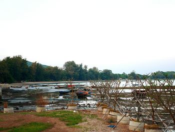 Boats in water against clear sky