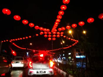 Illuminated christmas lights in city at night