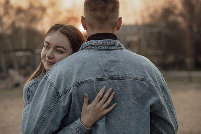 Stunning sensual young couple in love hug at the sunset, happy lifestyle concept