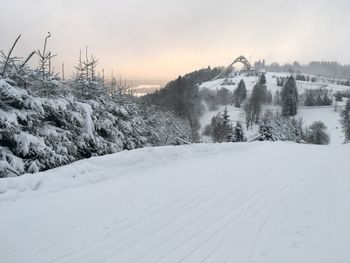 Snow covered landscape against sky