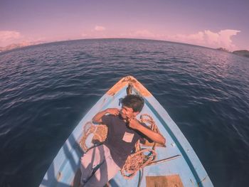 People at sea shore against sky