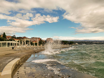 Panoramic view of sea and buildings against sky