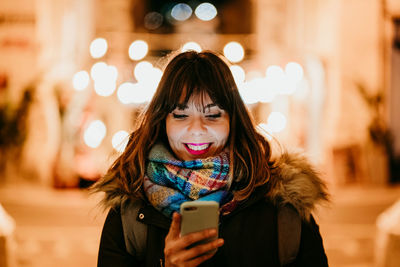 Portrait of young woman using smart phone outdoors