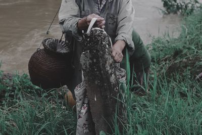 Low section of man working on field