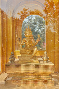 Buddha statue in temple against building