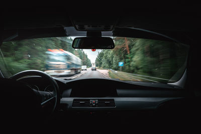 Car moving on road seen through windshield