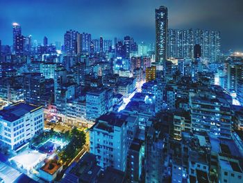 Aerial view of illuminated buildings in city at night