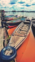 Boats moored on sea against sky