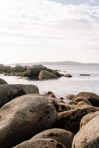 Rocks on beach against sky