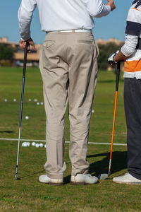 Low section of man standing on golf course