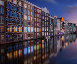 Reflections of dutch houses during blue hour in amsterdam.