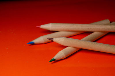High angle view of colored pencils over yellow background
